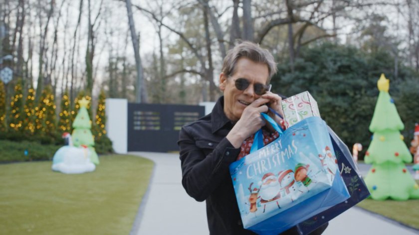 Kevin Bacon on the phone with holiday packages.