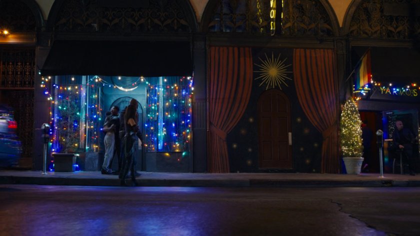 Mantis and Drax walk along a sidewalk at night.