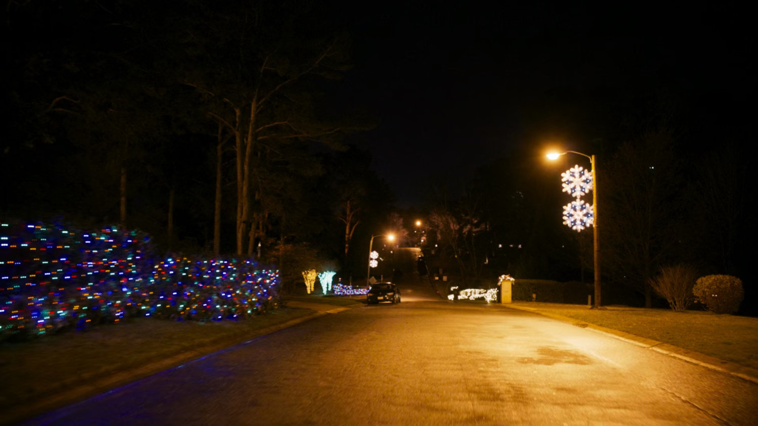 A street in a Beverly Hills neighborhood at night.