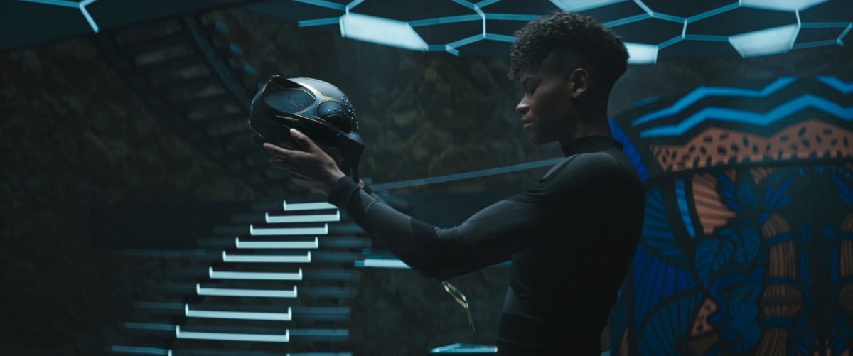 Shuri stares at the Black Panther helmet