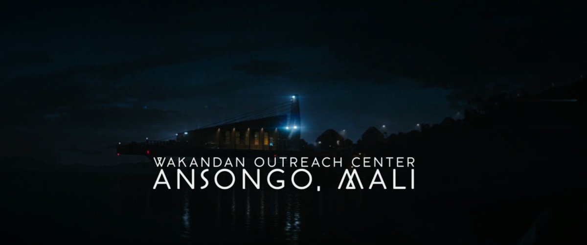 A coastal building at night. Text: Wakandan Outreach Center Ansongo, Mali