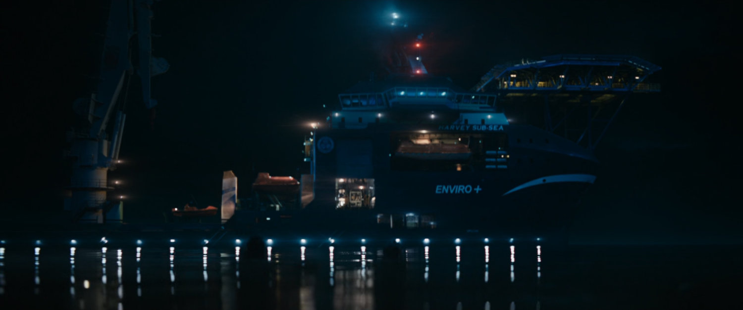 A boat at night on the water.