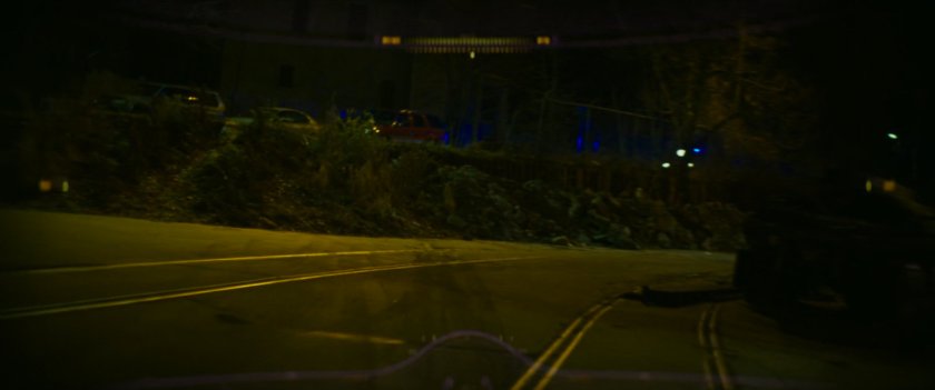 Road outside Boston warehouse at night.