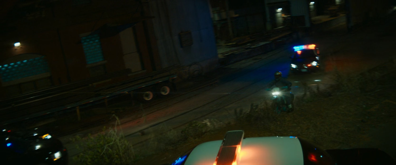 Road outside Boston warehouse at night.