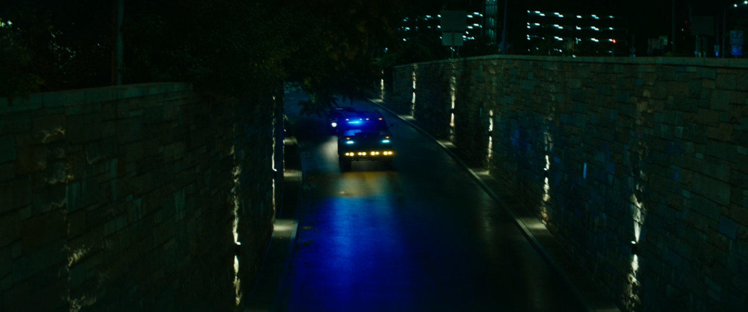 Emergency vehicles drive into a tunnel.