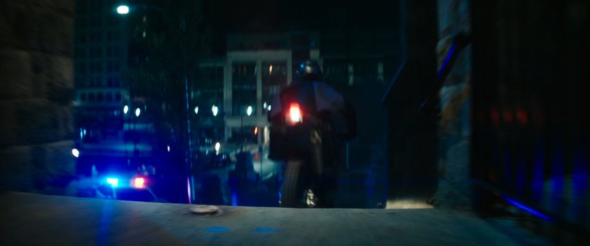 Motorcycle driving on church steps at night.