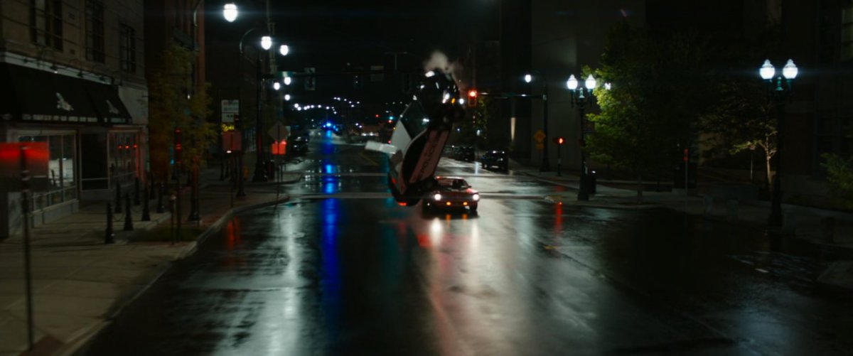 Police car flipping into air on Boston street at night.