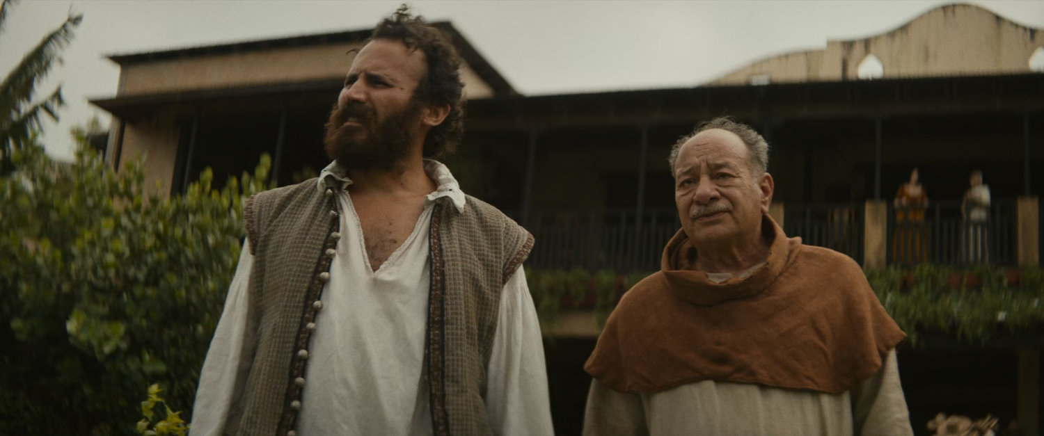 Two men in front of a plantation.