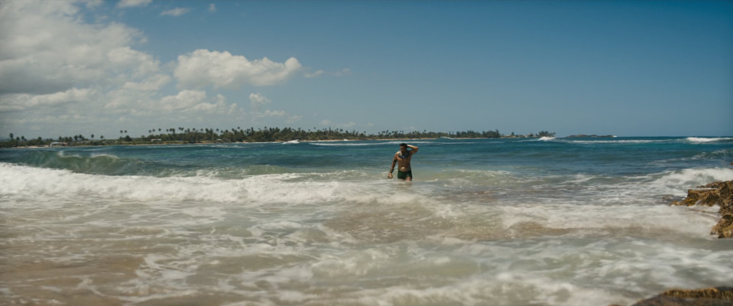 Namor walks out of ocean.