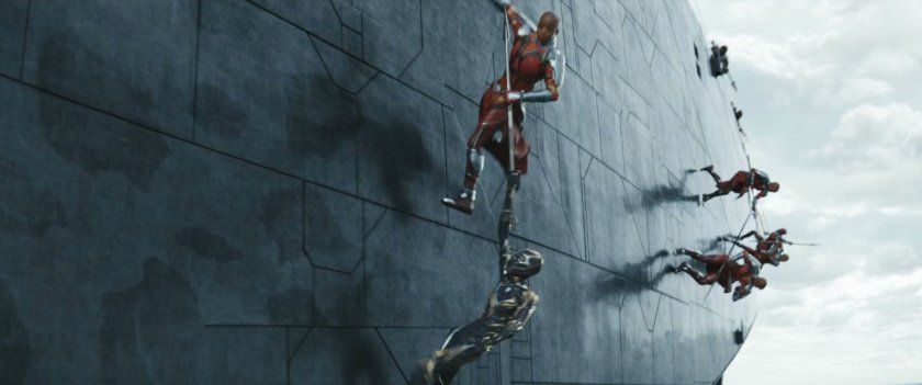 Dora Milaje warriors fight on the side a Wakandan boat.