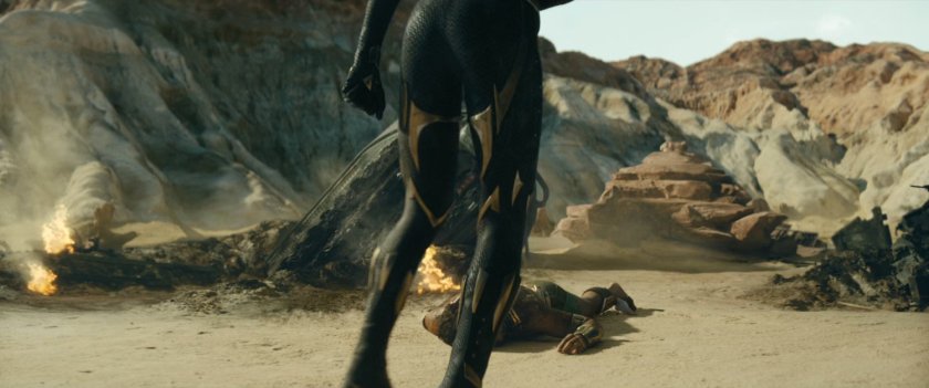 Shuri stands before defeated Namor on desert island.