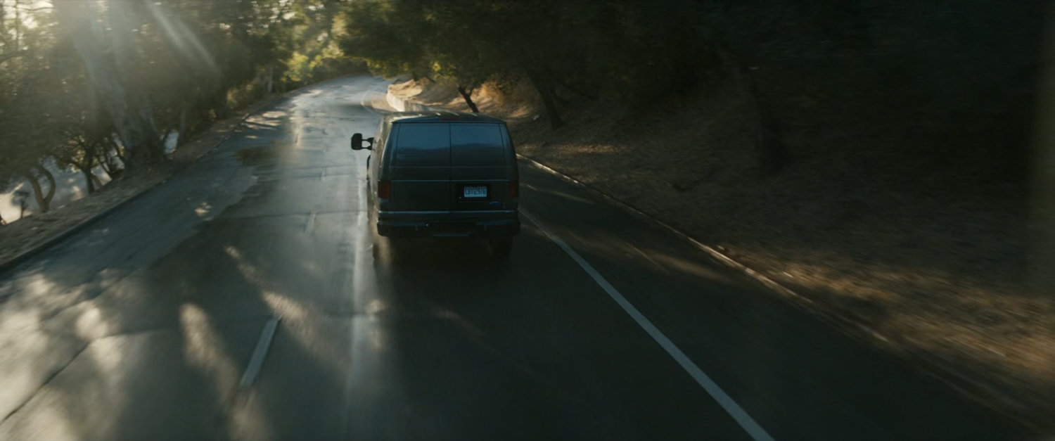 Van driving on road.