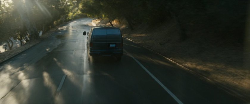 Van driving on road.