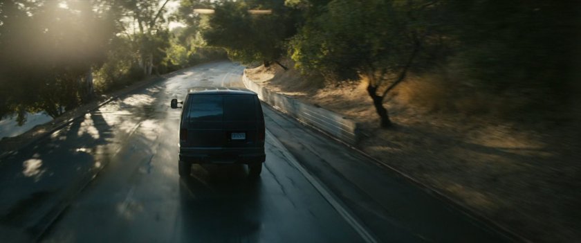 Van driving on road.