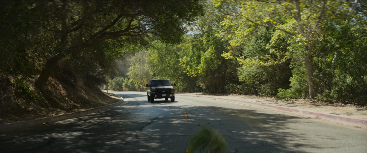 Van driving on road.