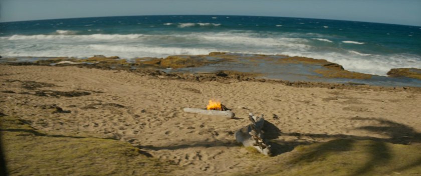 A campfire on a beach.