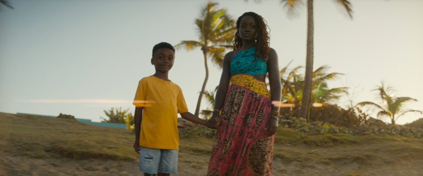 Nakia and a young boy, Toussaint, on a beach.