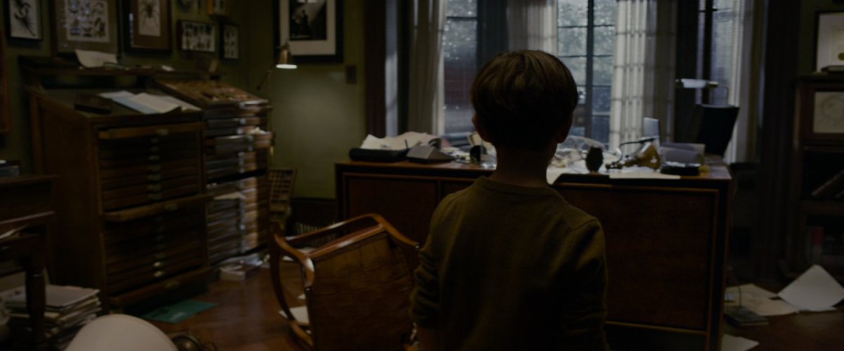 A young Peter Parker explores his fathers study at their house.