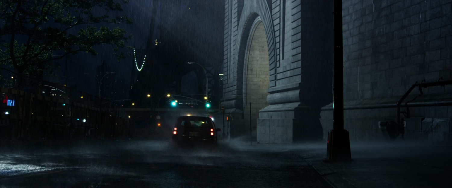 A rainy street at the footing of a bridge in New York City.