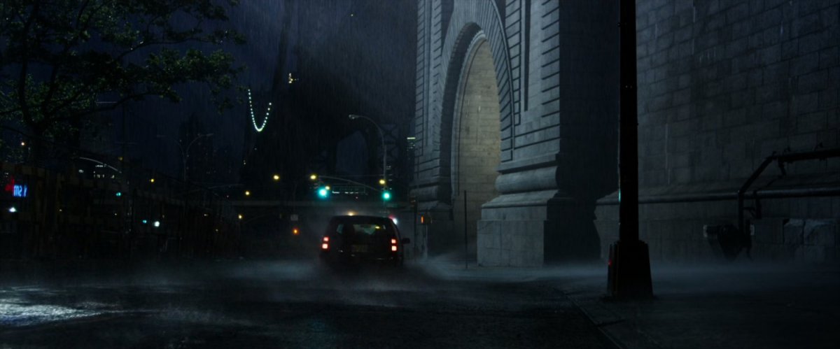 A rainy street at the footing of a bridge in New York City.