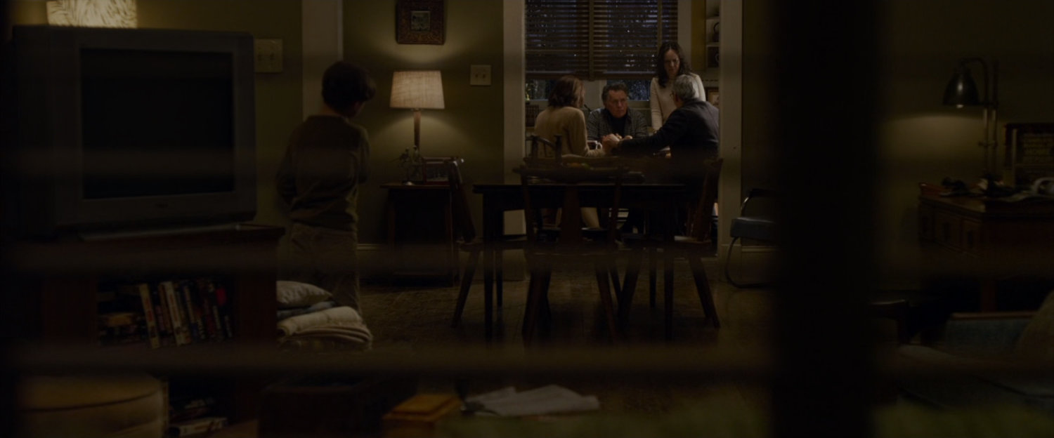 The Parkers sit around a table in Ben's house.