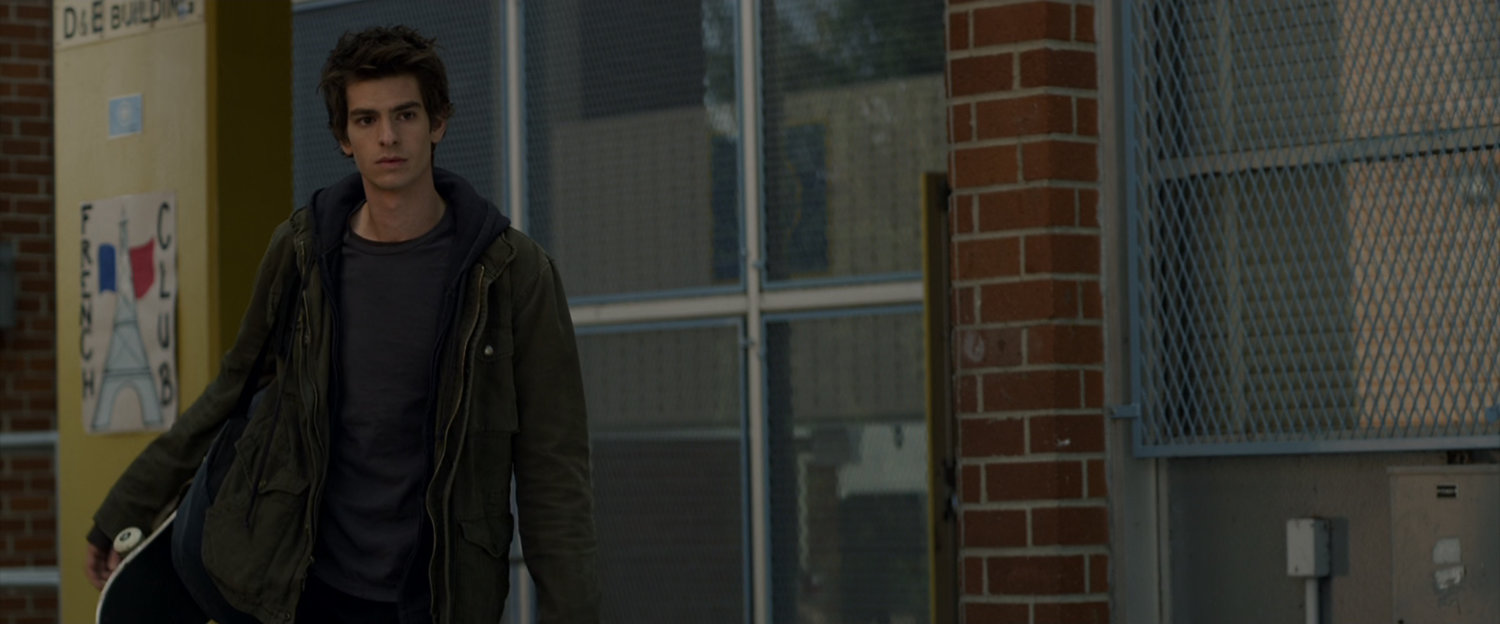 Peter Parker outside a school building.