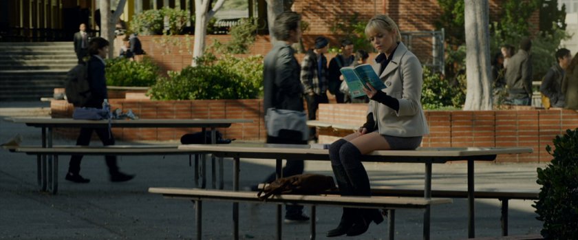 Gwen Stacy reading a book in the school quad.