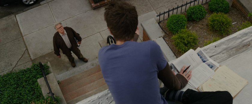 Peter Parker sits on the roof of his house talking to Uncle Ben.