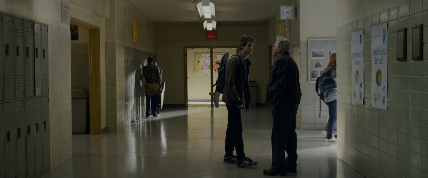 Peter Parker and Uncle Ben in school hallway.