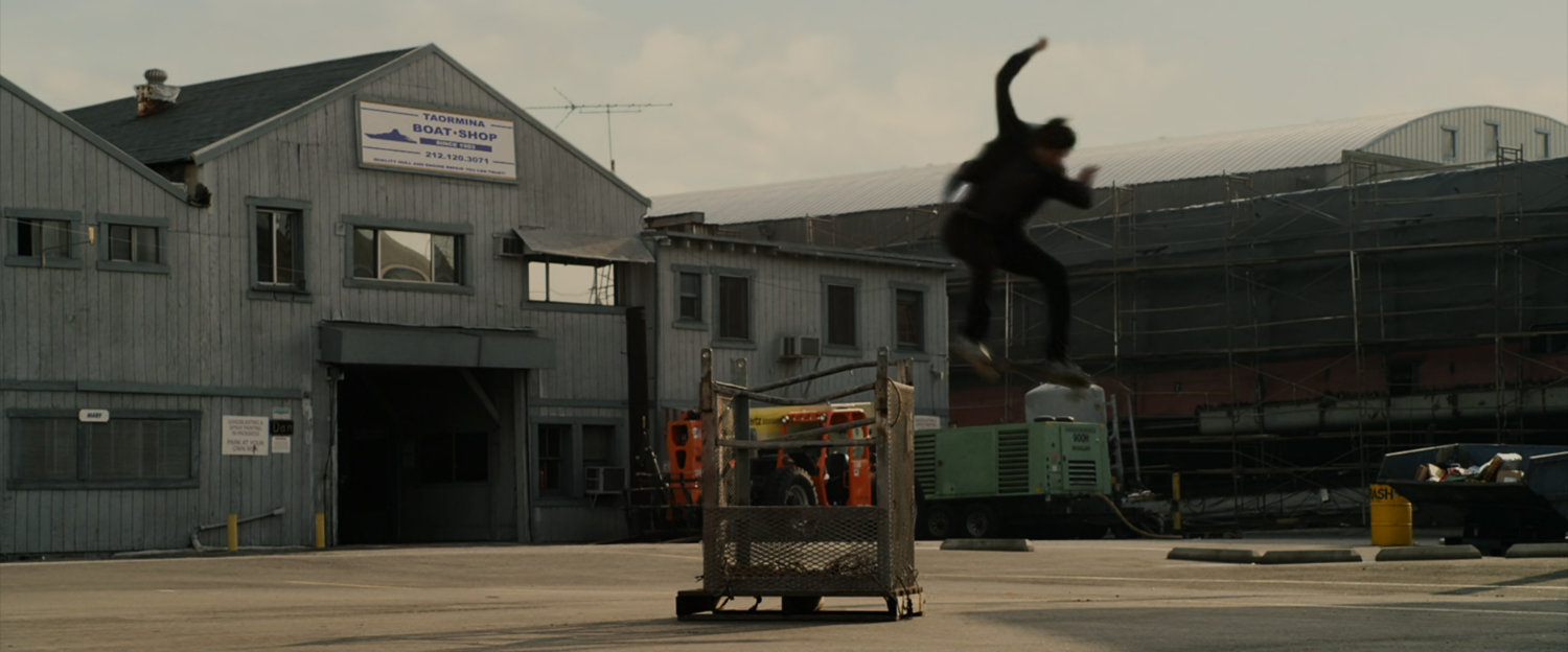 Peter Parker practices skateboarding at the marina.