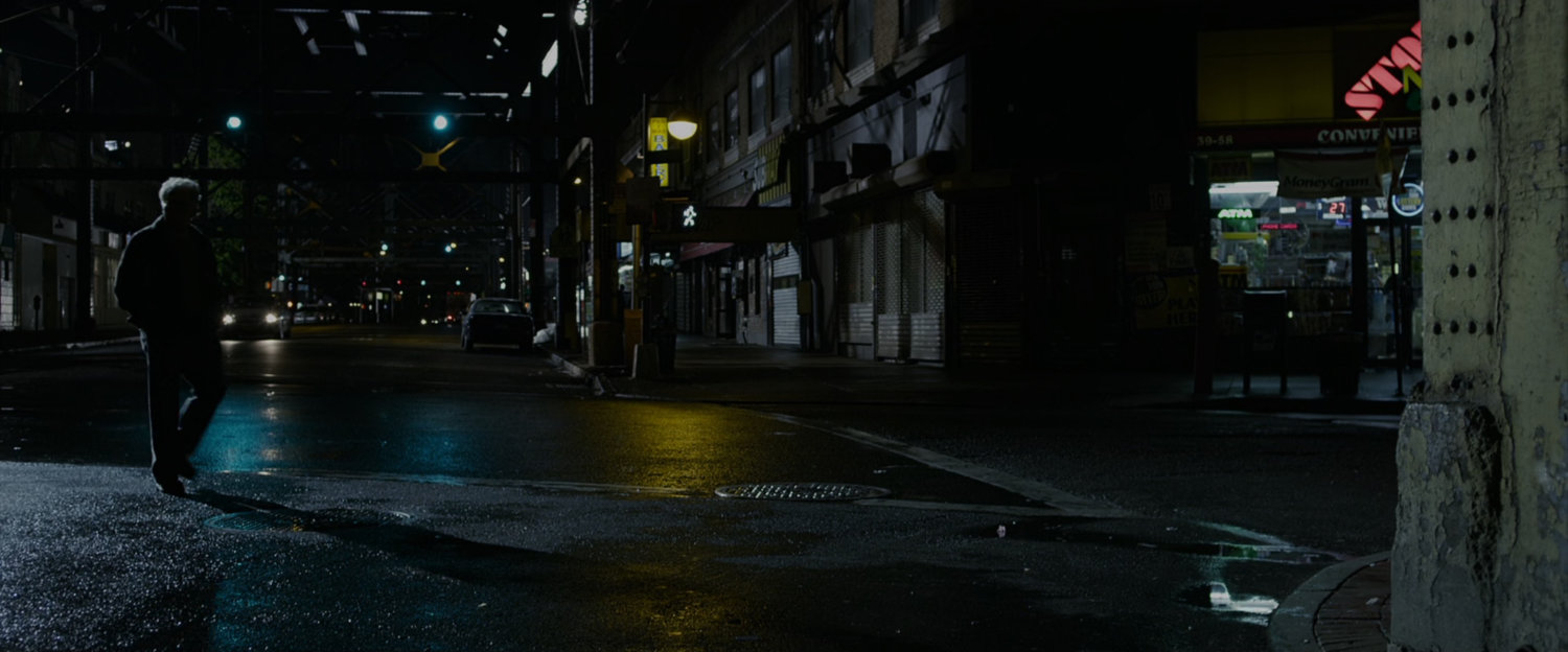 Uncle Ben walks on a street at night.