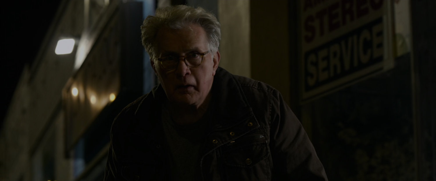 Uncle Ben on sidewalk at night.