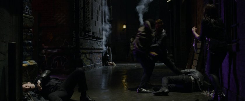 Peter Parker beating up some thugs in an alley.