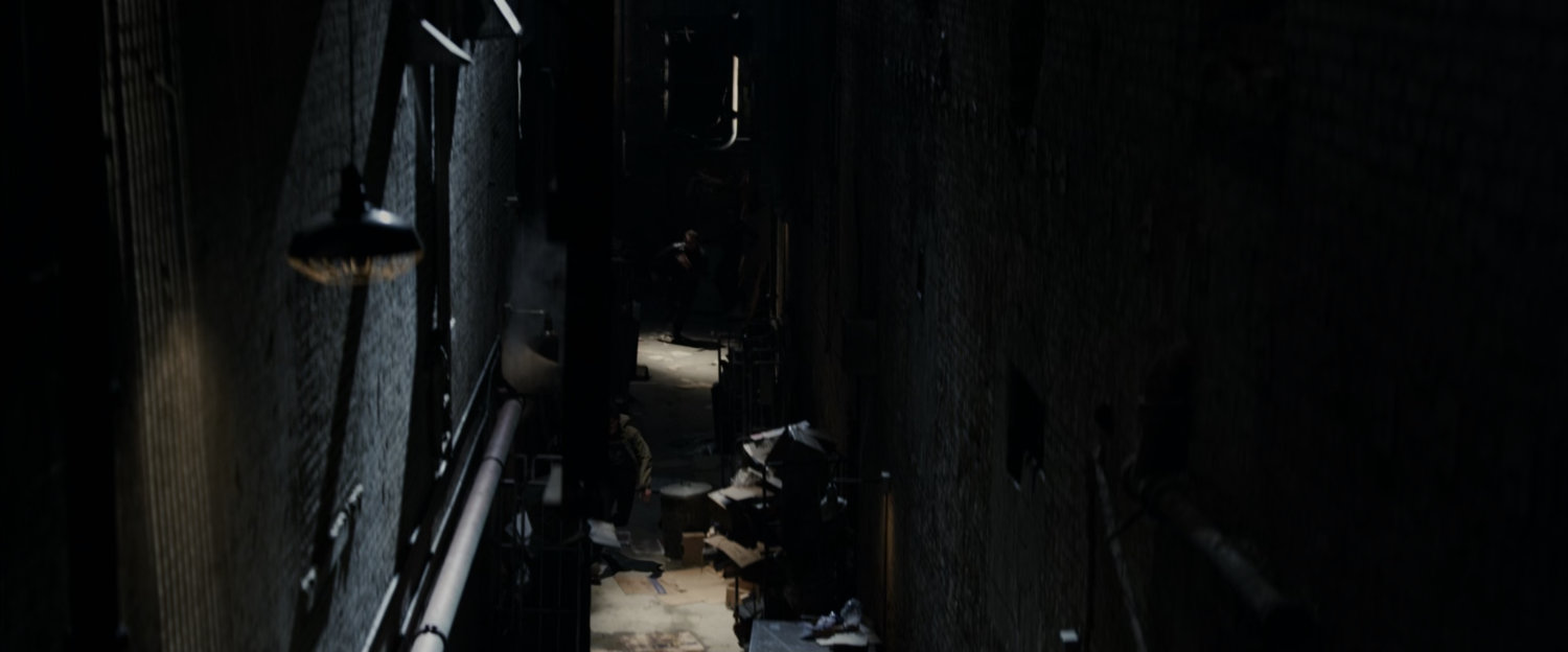 A dark New York alley.