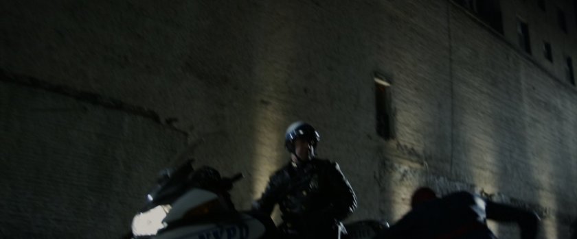 Spider-Man dodges the motorcycle officer.