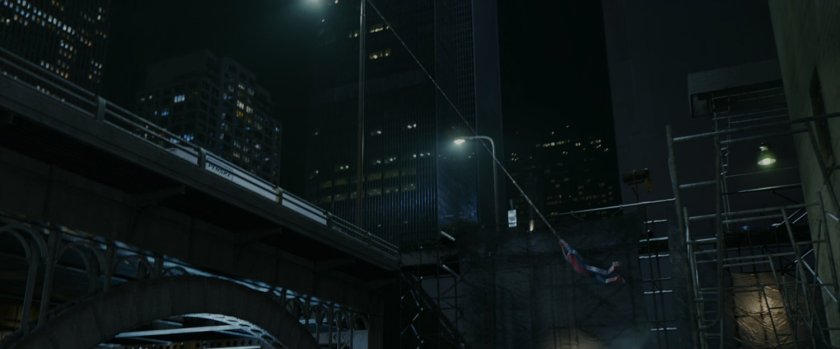 Spider-Man swings towards a bridge.