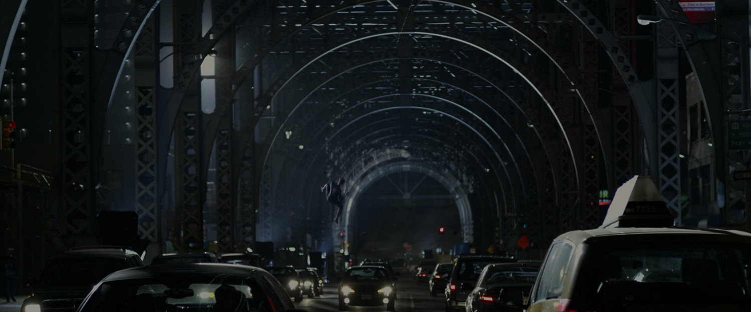 Spider-Man swinging under a bridge.