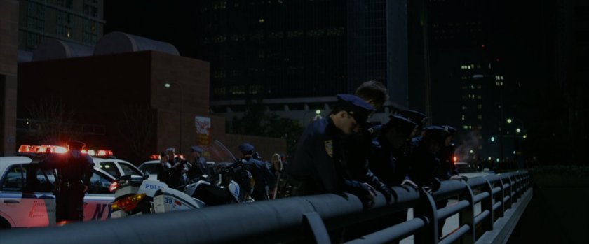 Police looking over the edge of a bridge.