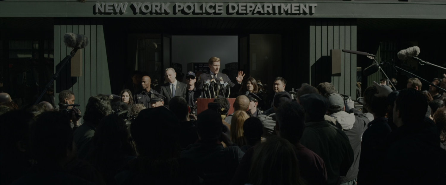 Captain Stacy addresses a crowd outside police headquarters.