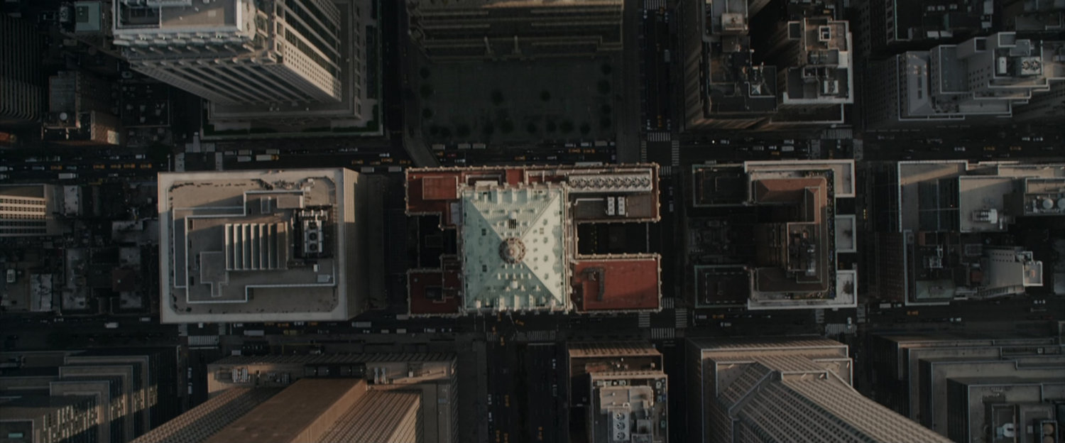 Aerial view straight down of New York City buildings and streets.