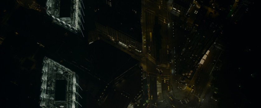 Aerial view of New York City at night, looking down on streets.