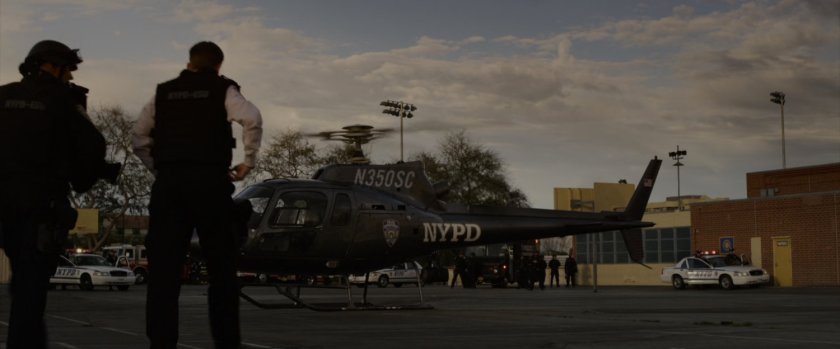 NYPD helicopter in the parking lot of high school.