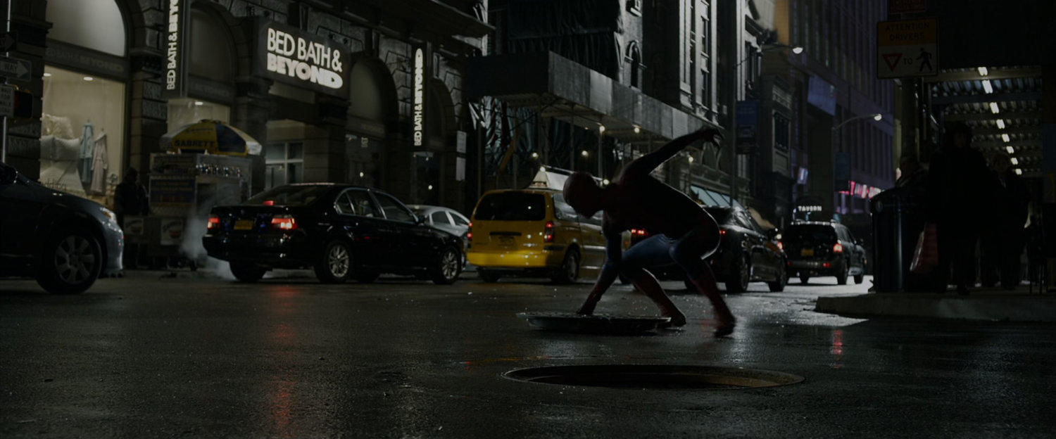 Spider-Man on New York street at night.