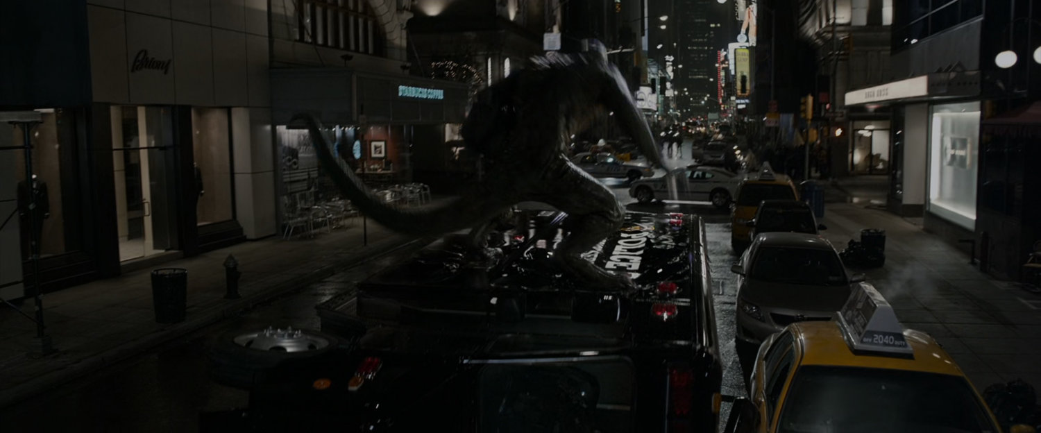 The Lizard riding on the top of a fire truck at night.
