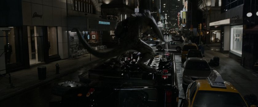 The Lizard riding on the top of a fire truck at night.