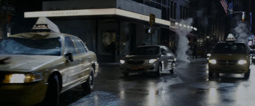 Cars skid to a halt in a New York street at night.