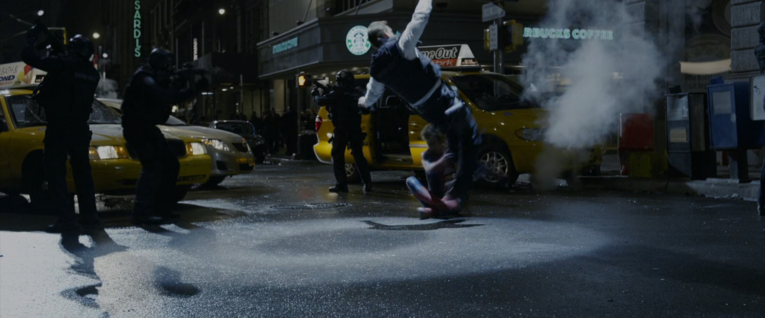 Spider-Man knocks down Captain Stacy as he removes the superhero's mask.