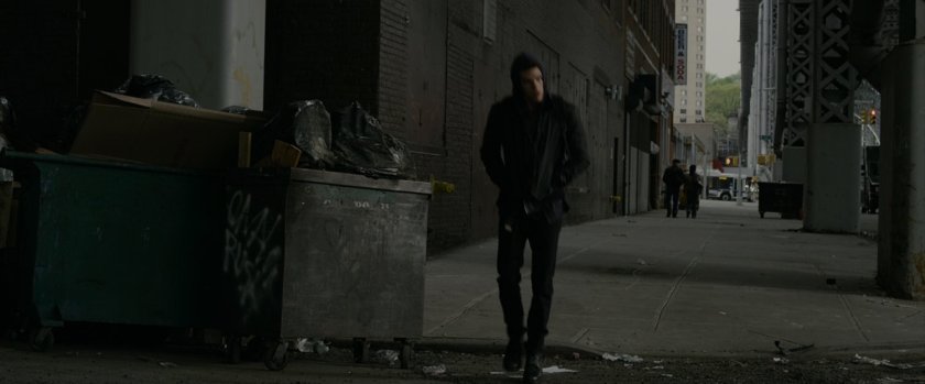 Peter Parker walks down sidewalk.