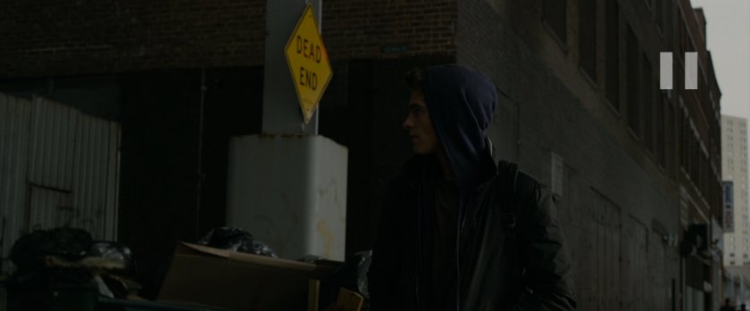 Peter Parker looking into alley.