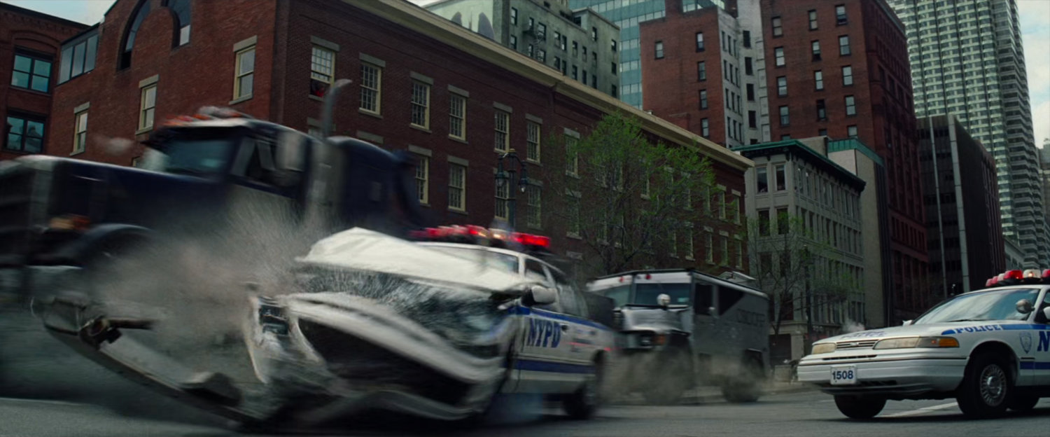 Tow truck crashes through police cars.